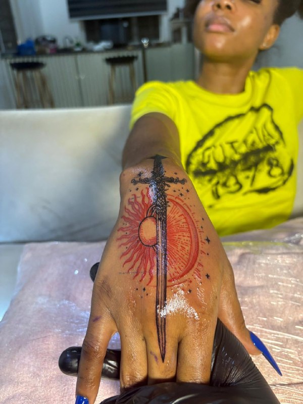 Sun sword tattoo